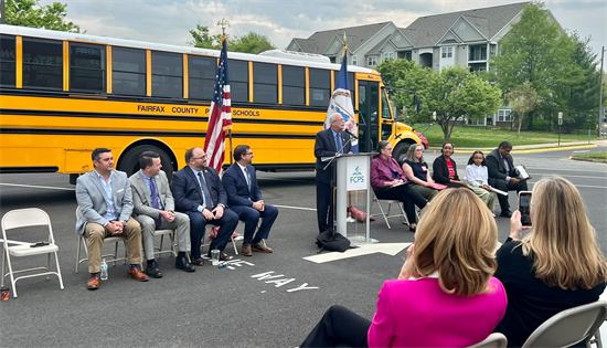 Rep. Connolly speaks in front of a brand new electric school bus.